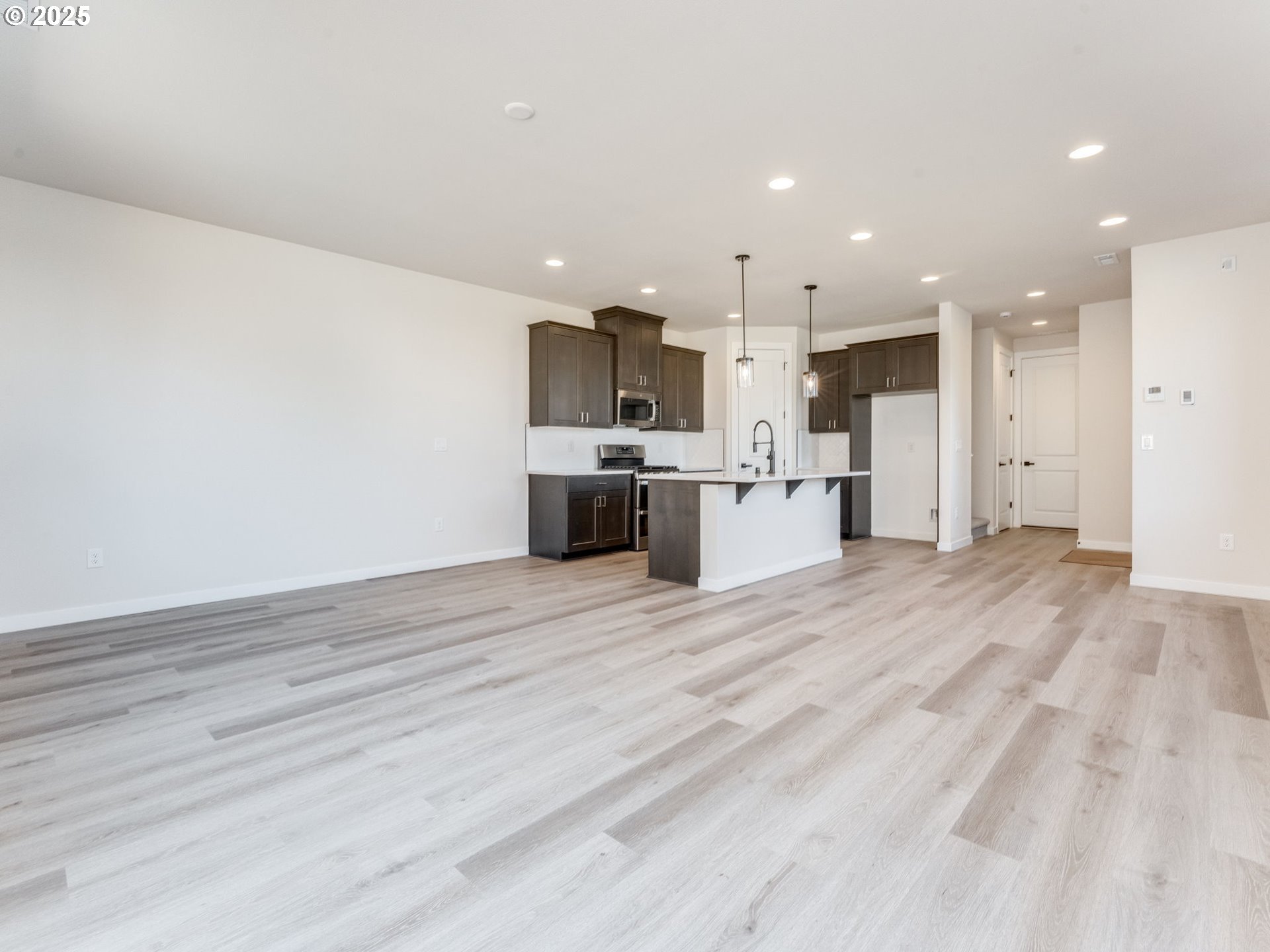 744 Northwest 178th Street Ridgefield, WA 98642 - Photo 8 of 25 a view of kitchen view with stainless steel appliances wooden cabinets and entryway