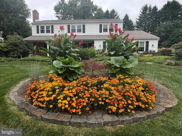 a front view of a house with a yard and garden