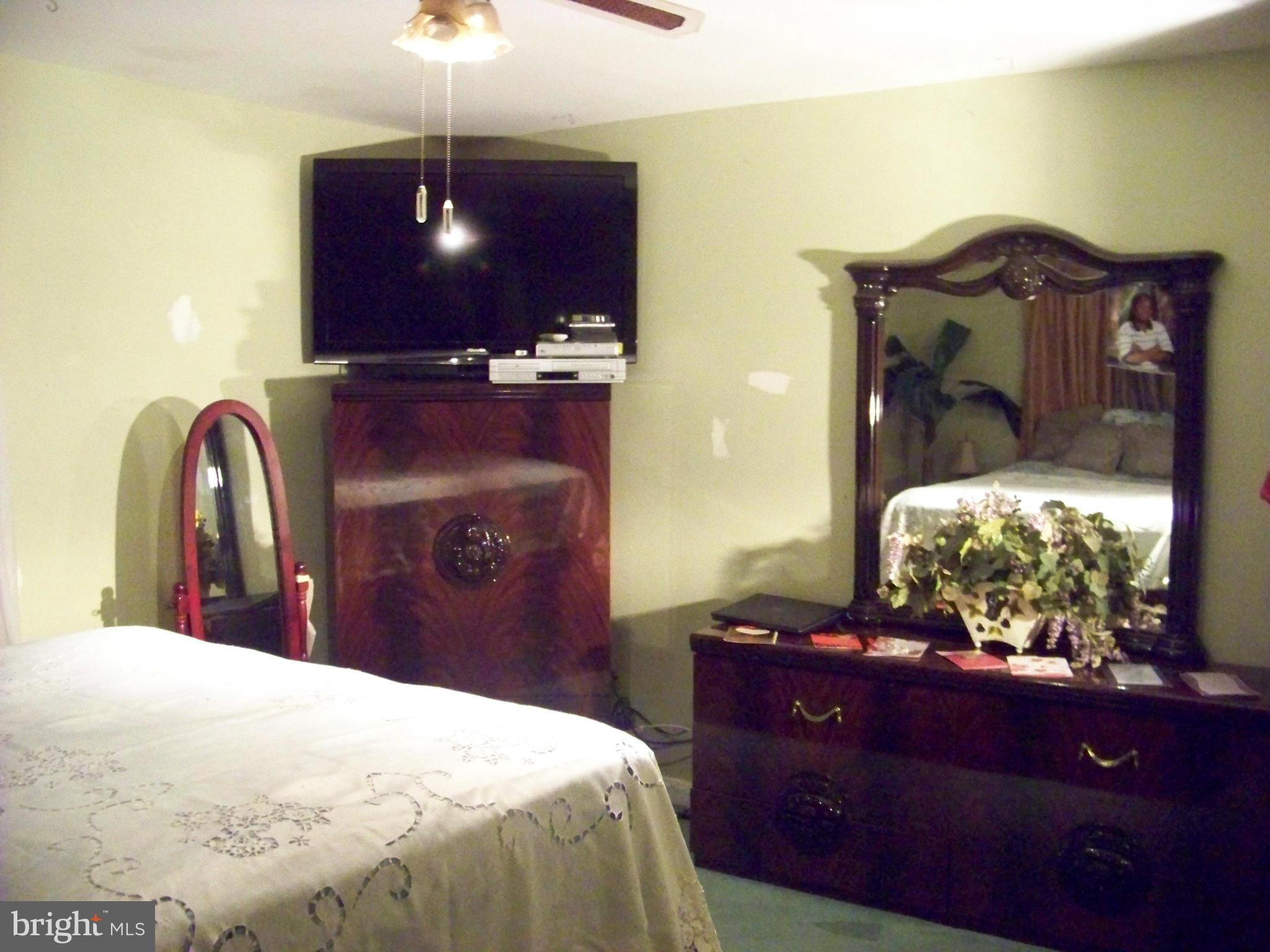 7970 Riggs Road, Unit 7970 Hyattsville, MD 20783 - Photo 16 of 23 a bedroom with a bed and dresser