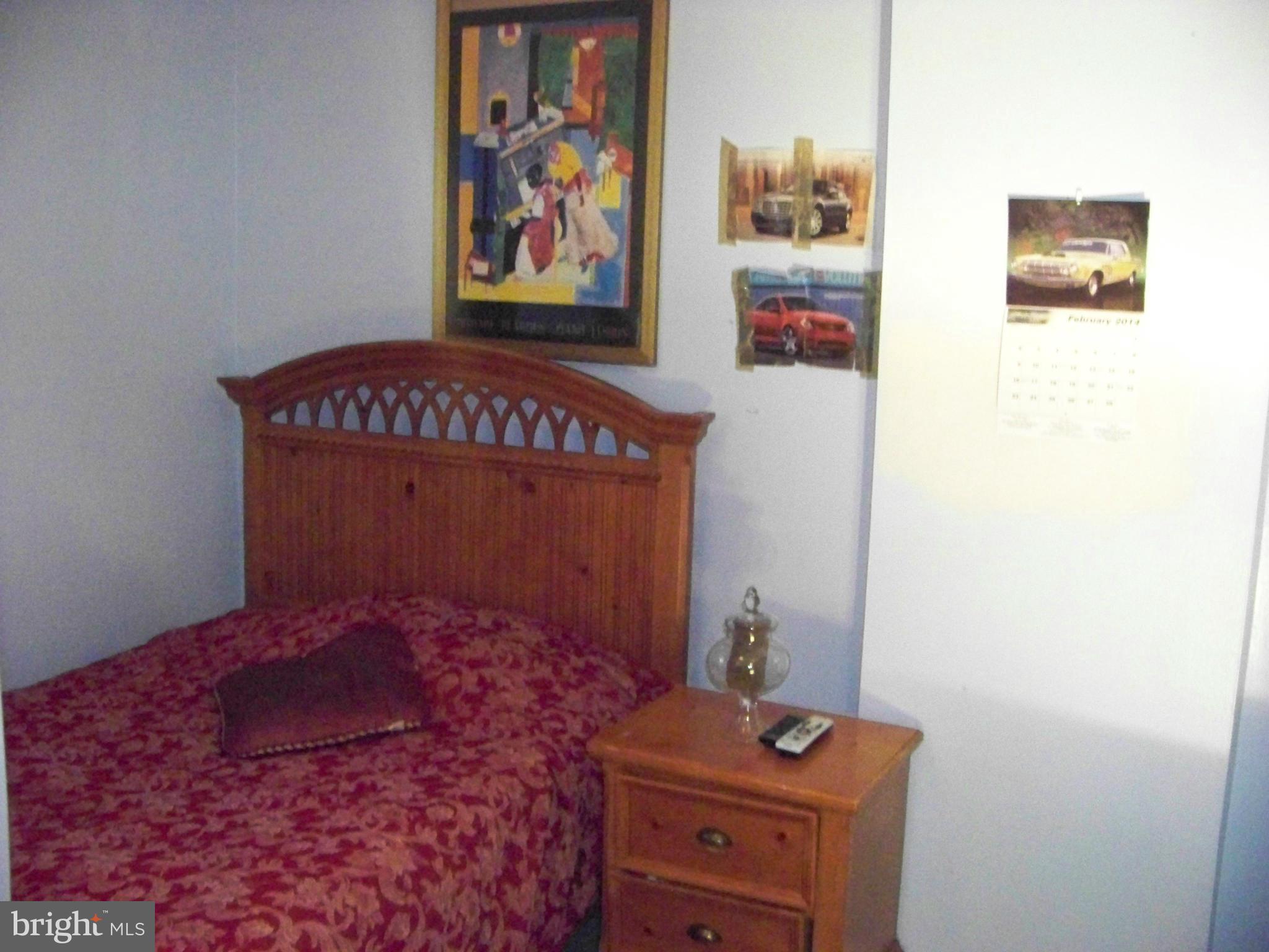 7970 Riggs Road, Unit 7970 Hyattsville, MD 20783 - Photo 19 of 23 a room with painting on the wall and a table