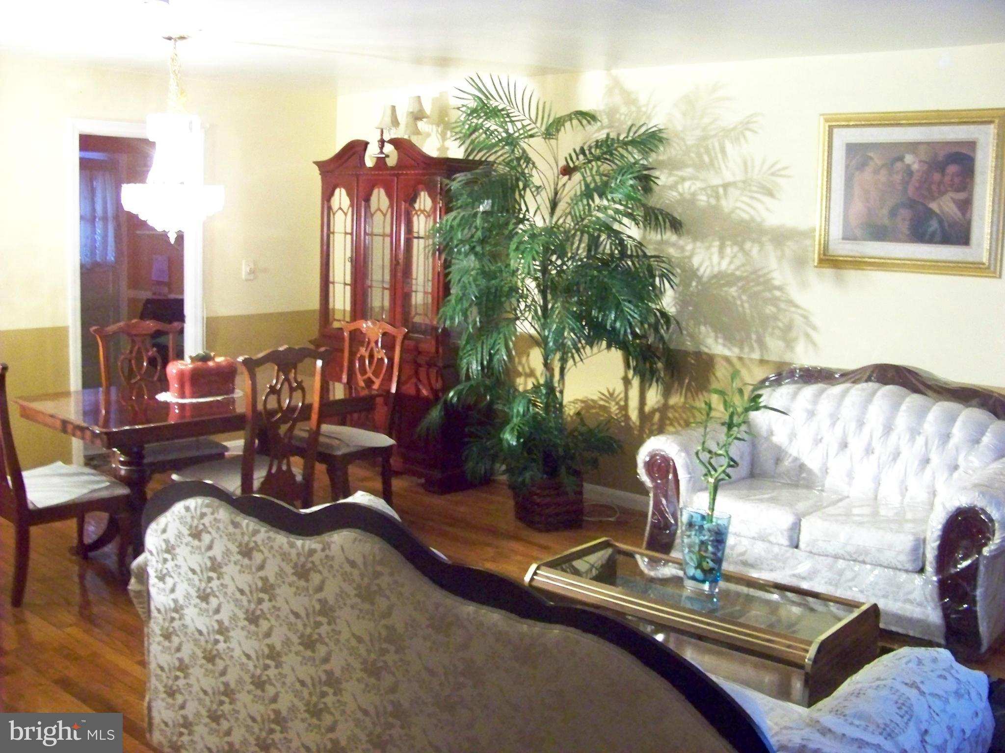 7970 Riggs Road, Unit 7970 Hyattsville, MD 20783 - Photo 6 of 23 a view of a livingroom with furniture and lamp