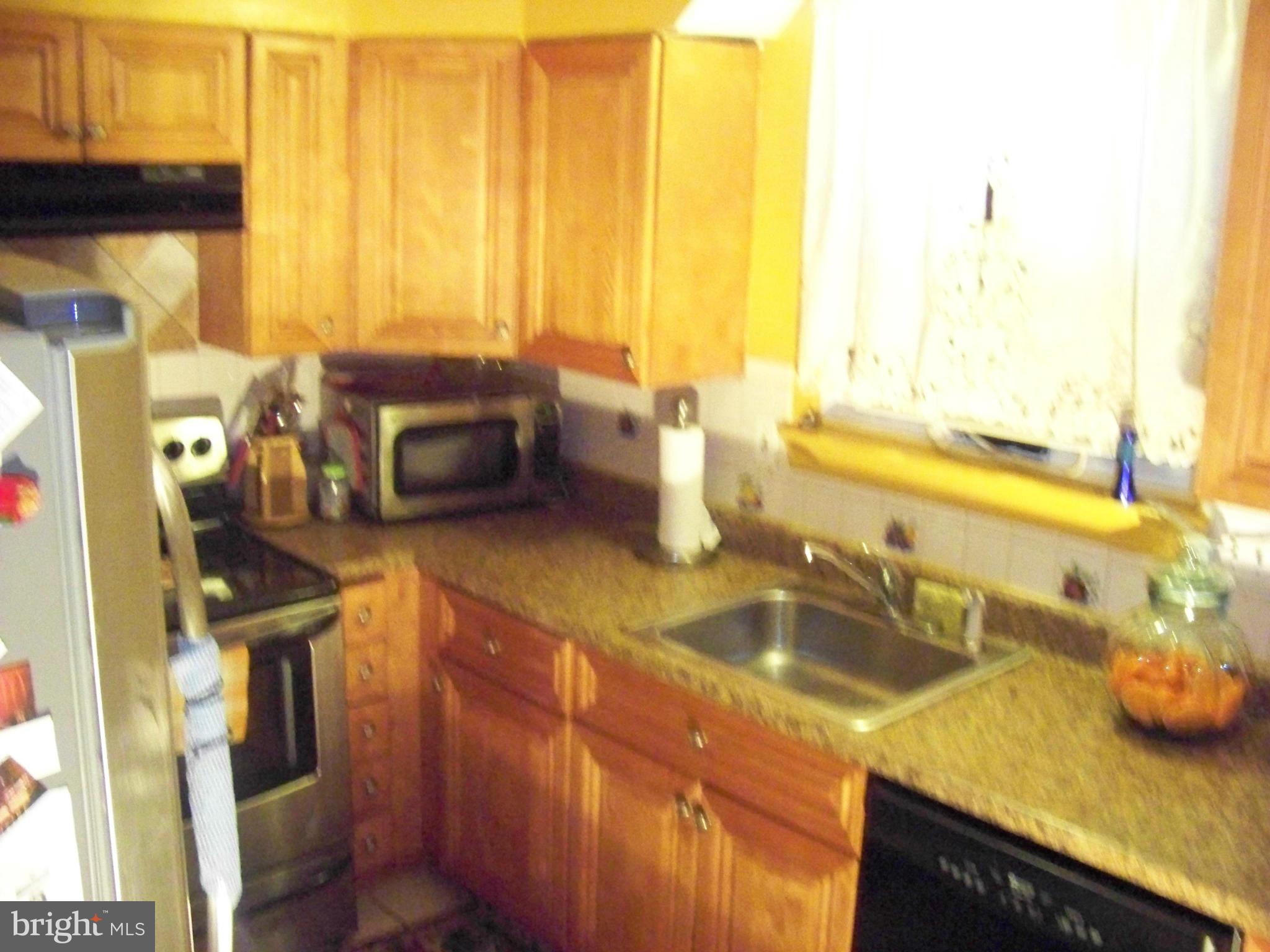7970 Riggs Road, Unit 7970 Hyattsville, MD 20783 - Photo 9 of 23 a kitchen with a sink and a window
