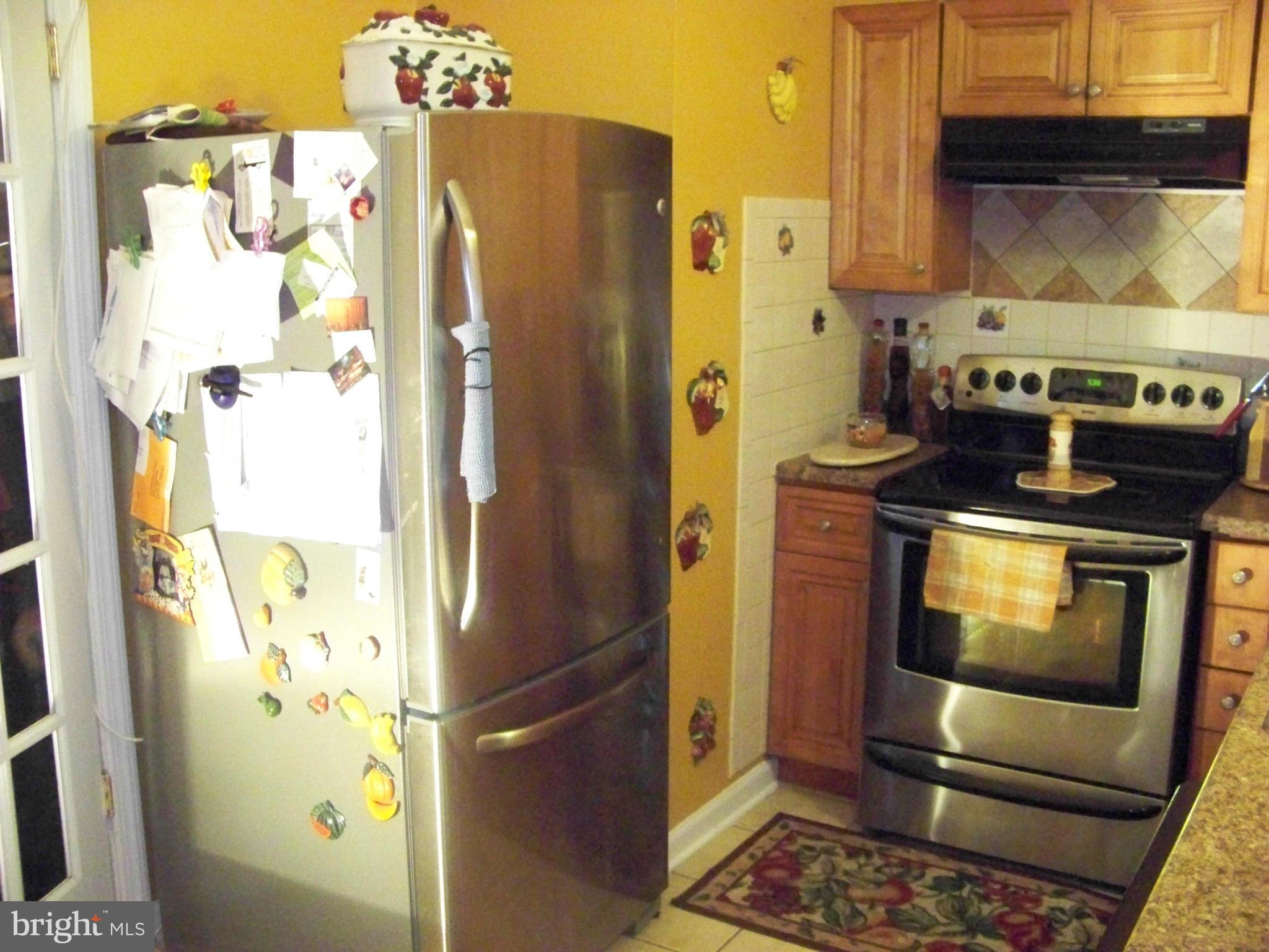 7970 Riggs Road, Unit 7970 Hyattsville, MD 20783 - Photo 10 of 23 a bathroom with a stove and a refrigerator