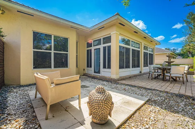 a view of a house with backyard and sitting area