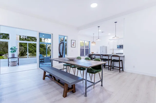 a living room with furniture a table and a large window