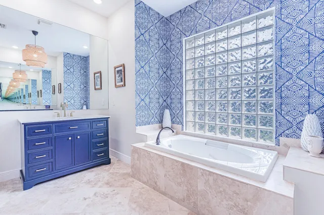 a bathroom with a tub sink and mirror