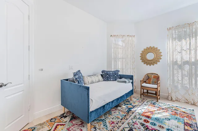 a bedroom with bed and a window