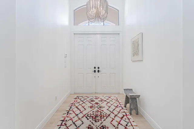 a view of a hallway with a chandelier
