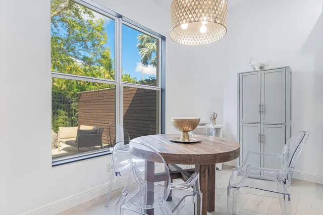 a view of a dining room with furniture and window