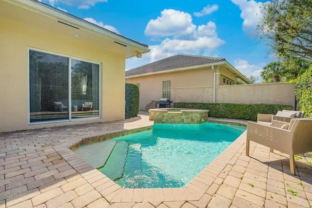 a view of a house with backyard porch and sitting area