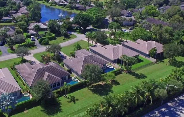 aerial view of a house with garden space and street view