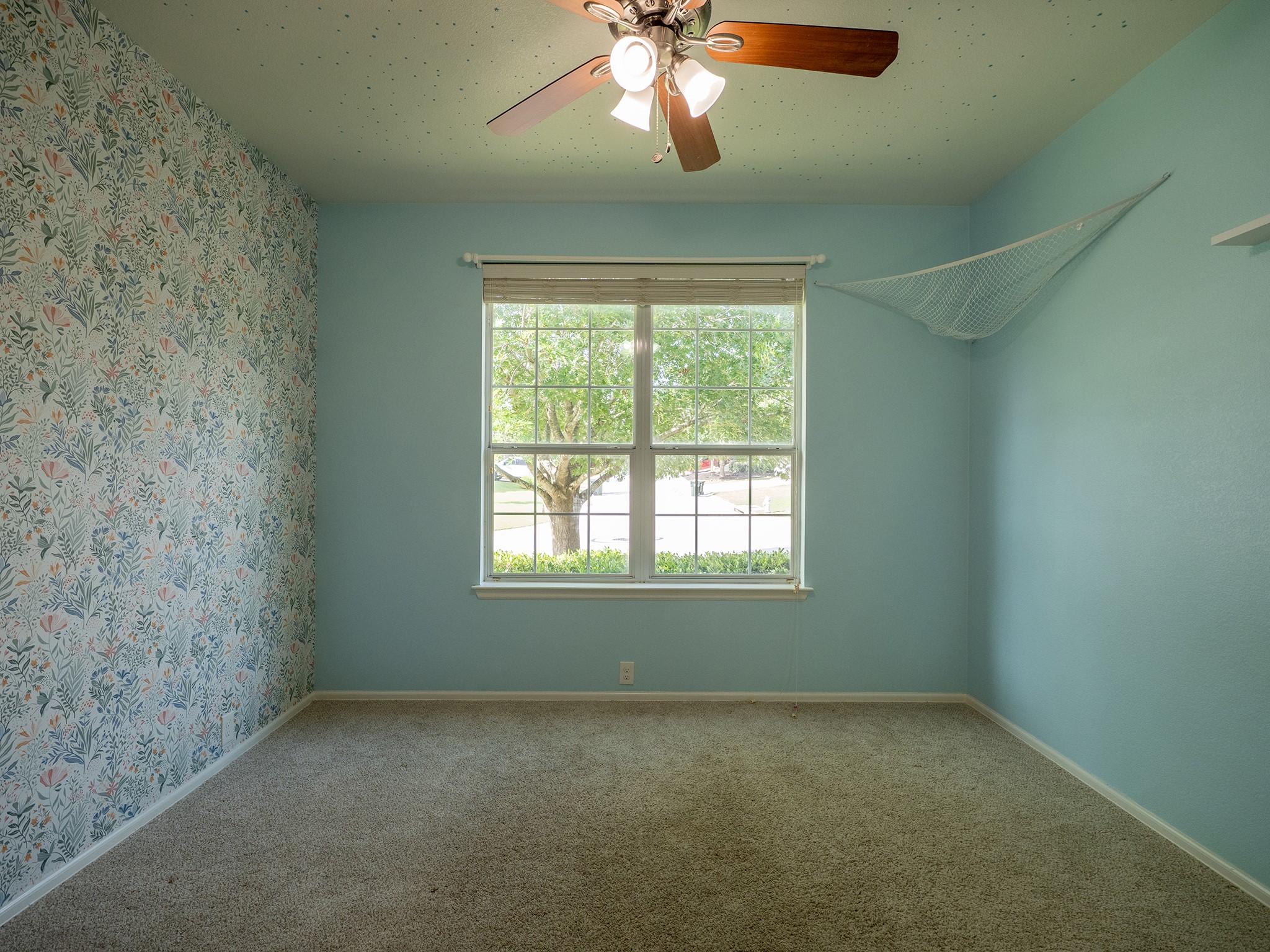572 Big Meadow Road Austin, TX 78737 - Photo 20 of 32 A well-lit bedroom provides comfort and serenity, featuring plush carpeting and a broad window.