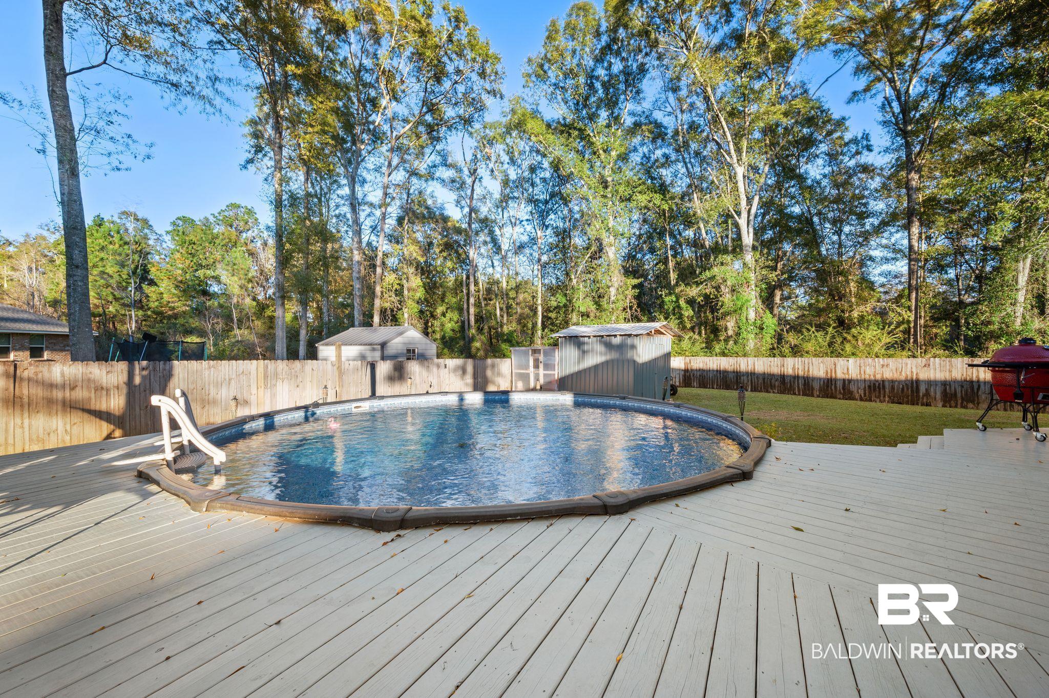 9366 Fox Run Court Semmes, AL 36575 - Photo 25 of 29 View of swimming pool with a wooden deck