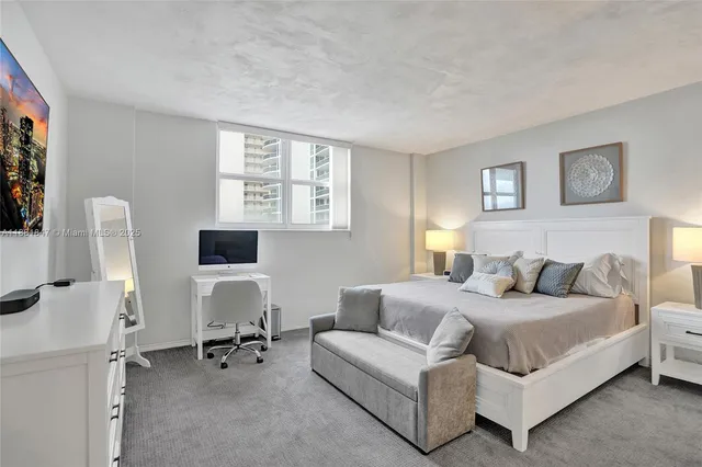 a bedroom with a bed couch and a window