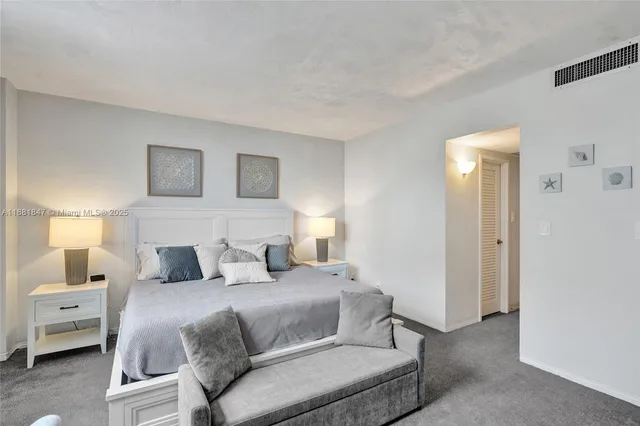 a bedroom with a bed and a lamp