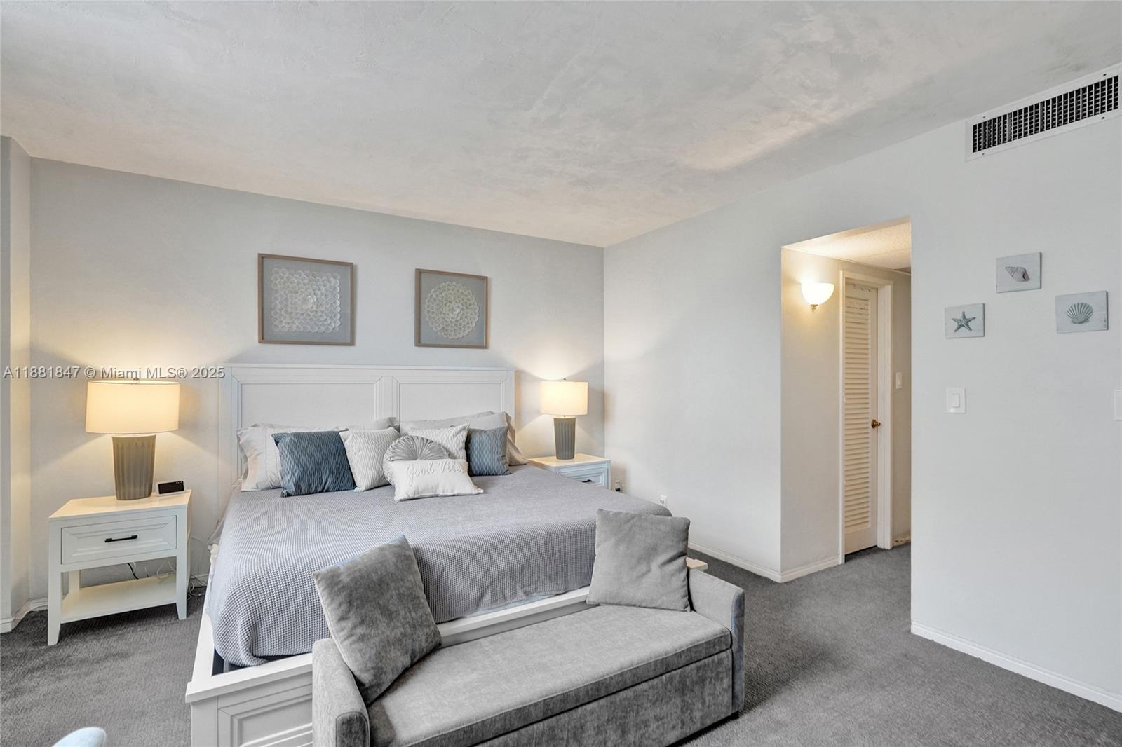 4250 Galt Ocean Drive, Unit 4P Fort Lauderdale, FL 33308 - Photo 12 of 29 a bedroom with a bed and a lamp