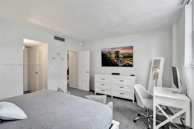 a bedroom with furniture and a flat screen tv