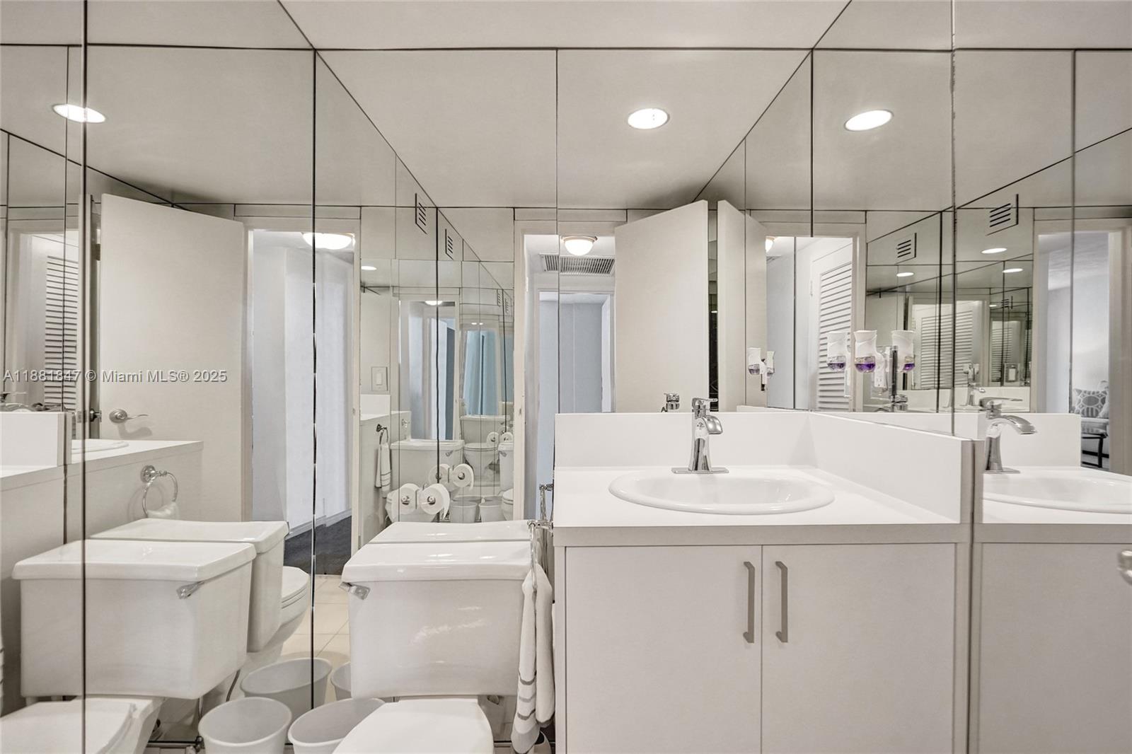 4250 Galt Ocean Drive, Unit 4P Fort Lauderdale, FL 33308 - Photo 14 of 29 a bathroom with a sink and mirror with toilet