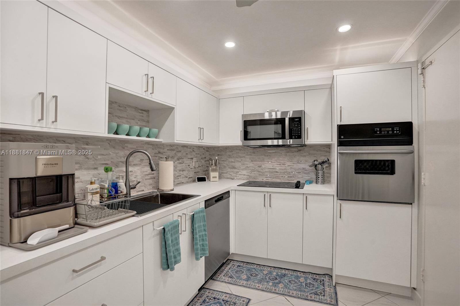 4250 Galt Ocean Drive, Unit 4P Fort Lauderdale, FL 33308 - Photo 4 of 29 a kitchen with stainless steel appliances granite countertop a stove a sink and a microwave