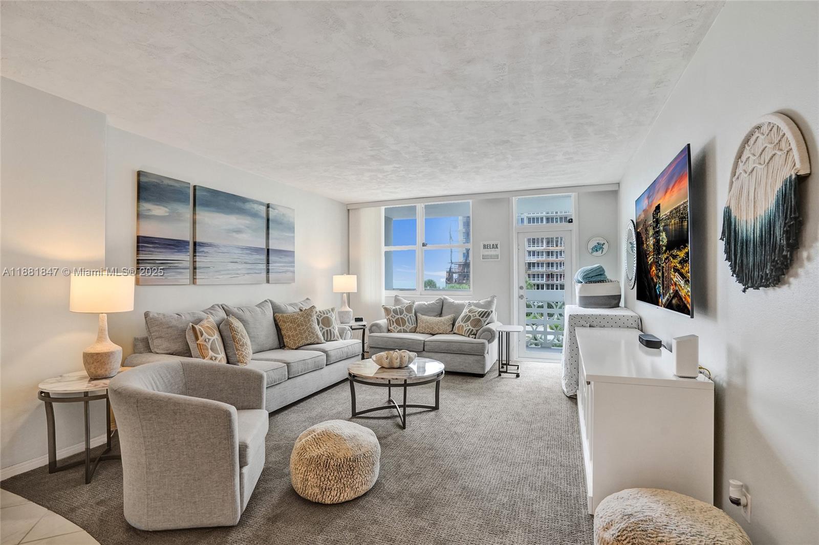 4250 Galt Ocean Drive, Unit 4P Fort Lauderdale, FL 33308 - Photo 5 of 29 a living room with furniture and a flat screen tv