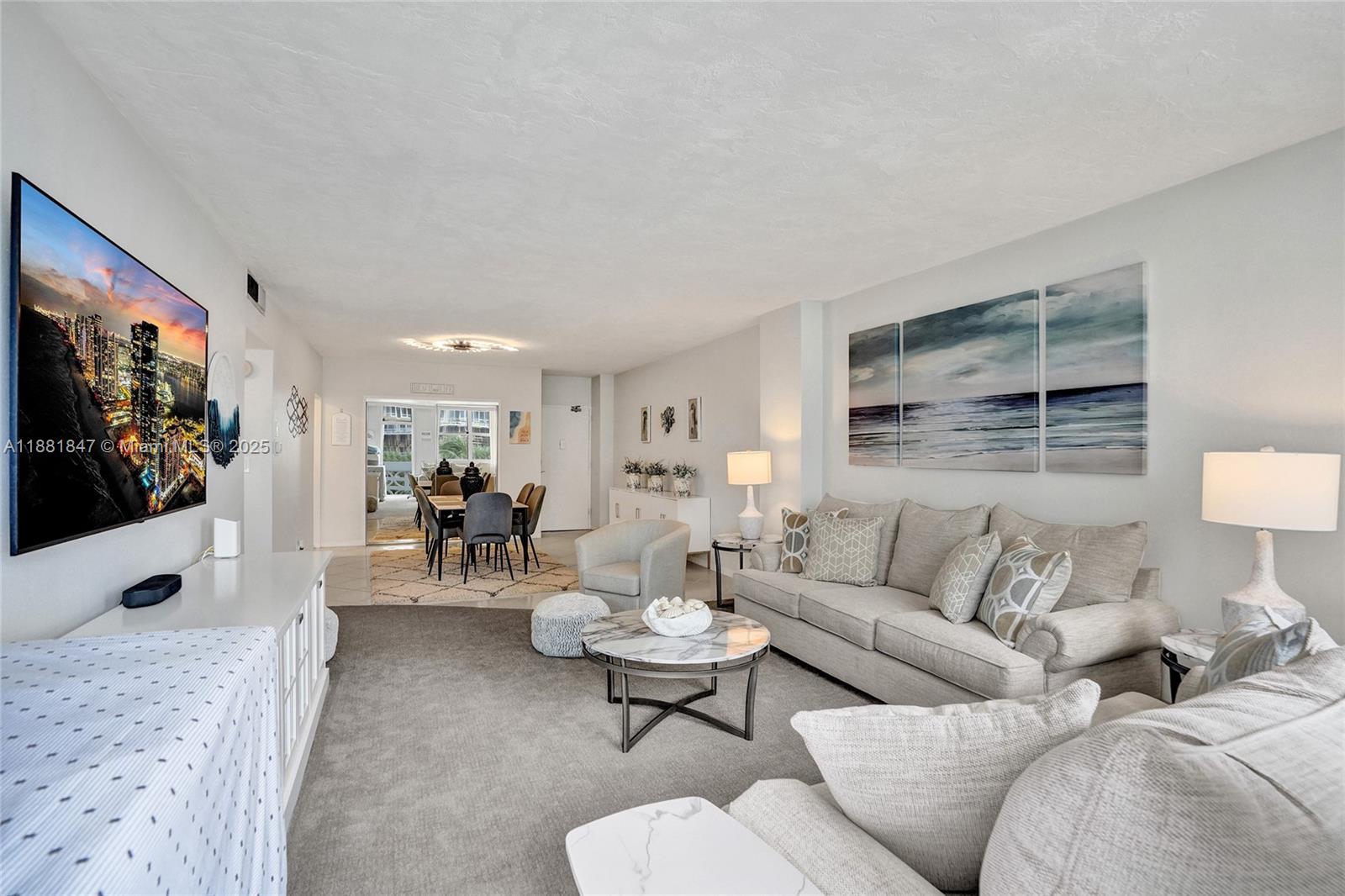 4250 Galt Ocean Drive, Unit 4P Fort Lauderdale, FL 33308 - Photo 7 of 29 a living room with furniture and a flat screen tv