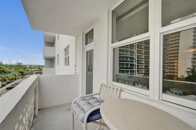 a balcony with table and chairs