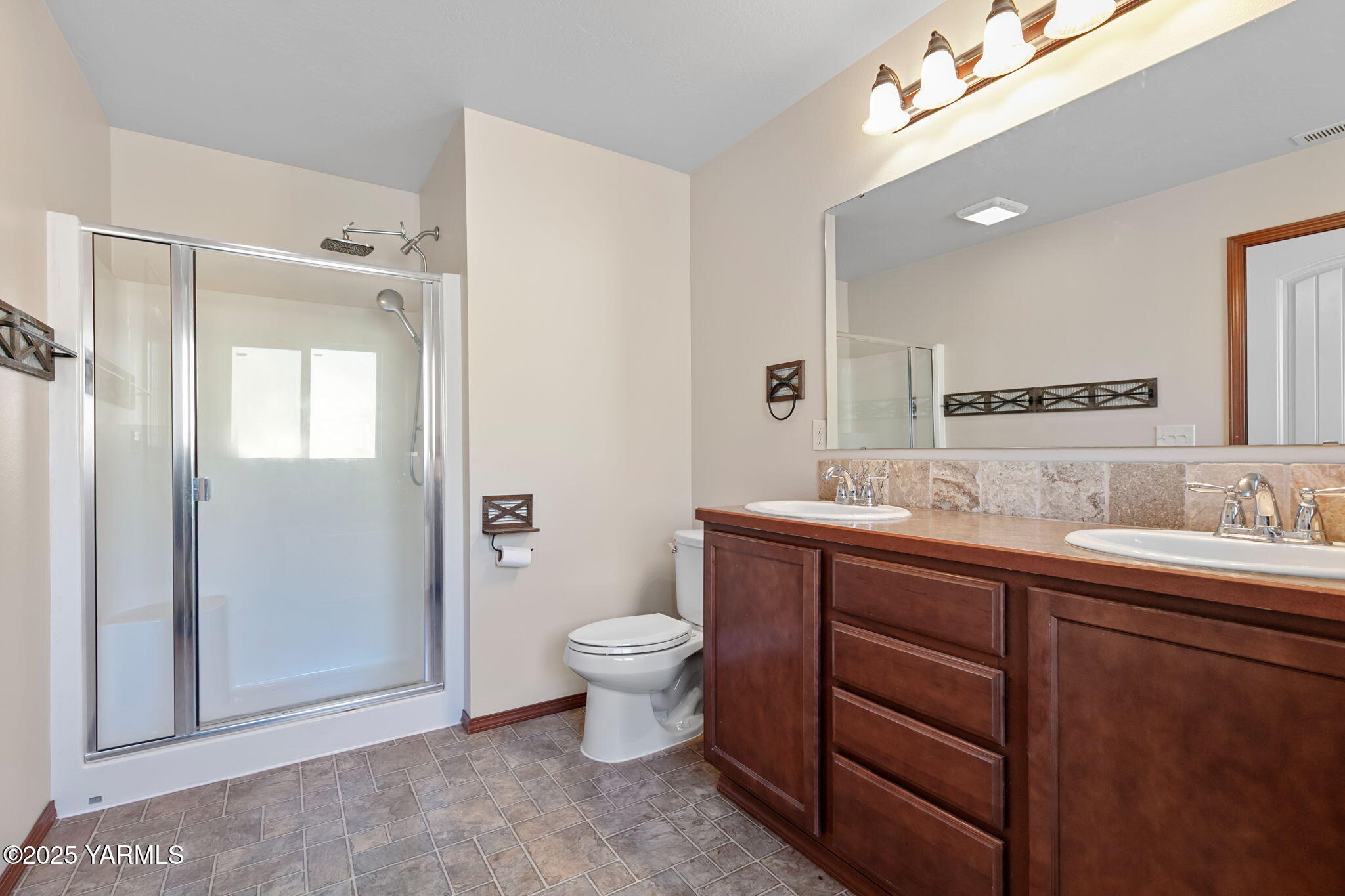 1101 Elk Ridge Lane Selah, WA 98942 - Photo 15 of 28 a spacious bathroom with a toilet sink and mirror