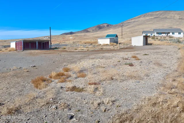 a front view of a house with a dirt road