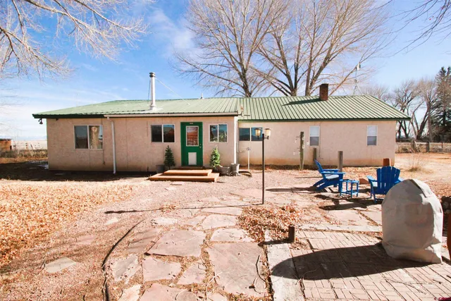 a view of a patio with a table chairs and wooden fence