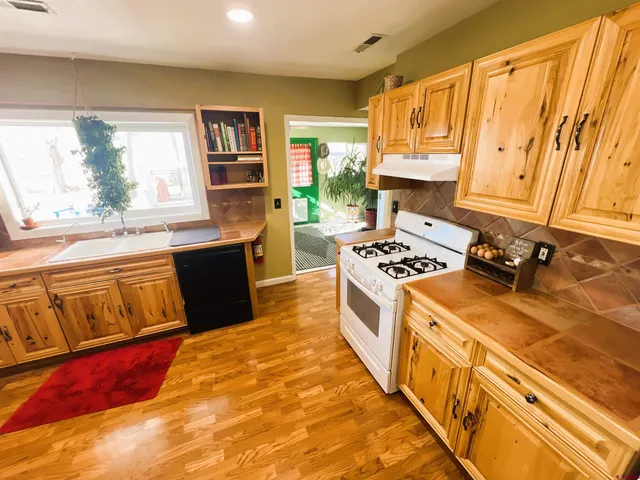 a kitchen with wooden cabinets and a stove