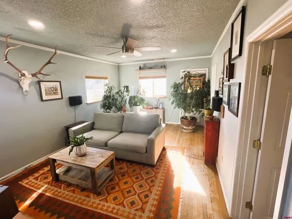 a living room with furniture and a chandelier