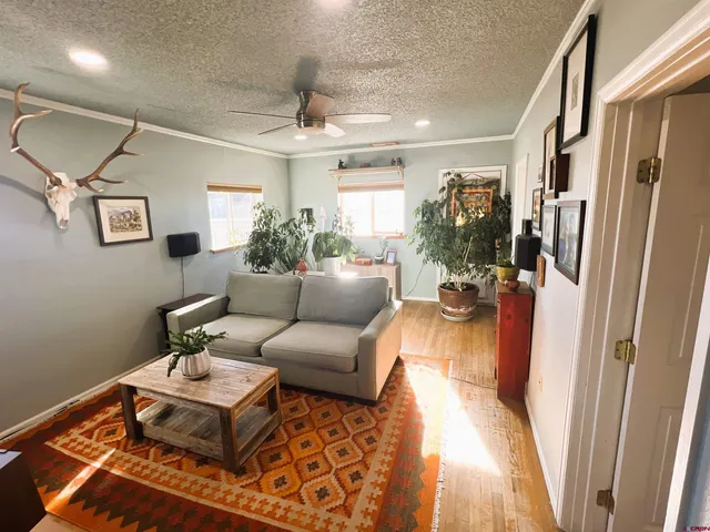 a living room with furniture and a chandelier