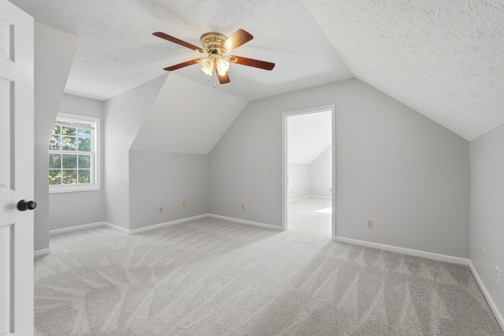 4877 Swafford Road Cookeville, TN 38501 - Photo 17 of 28 an empty room with windows and chandelier fan