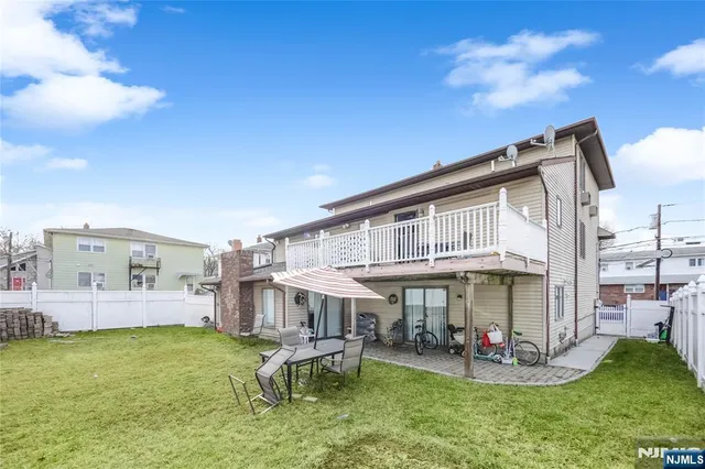 a view of a house with a yard balcony and sitting area