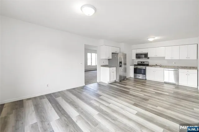 a view of kitchen with wooden floor