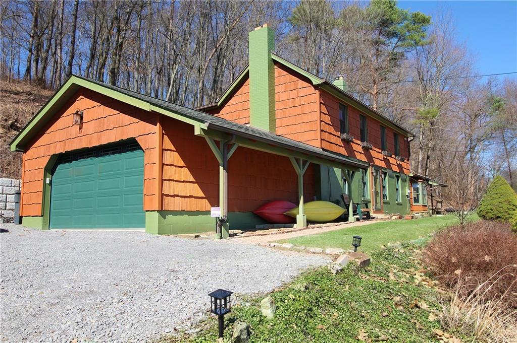 a view of a house with a yard and sitting area