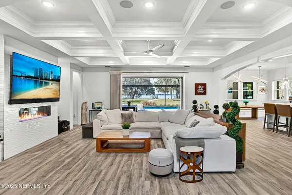a living room with furniture and a flat screen tv