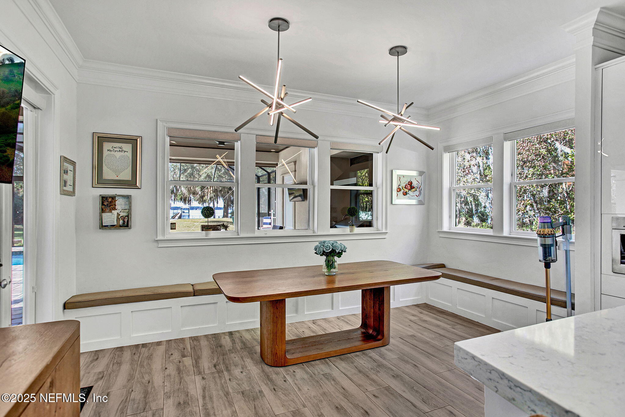 13224 Mandarin Road Jacksonville, FL 32223 - Photo 26 of 36 a dining room with wooden floor a chandelier a wooden table and chairs