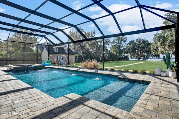 a view of a house with backyard and a patio