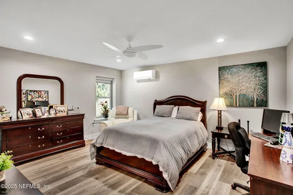 a bedroom with a bed and a flat screen tv