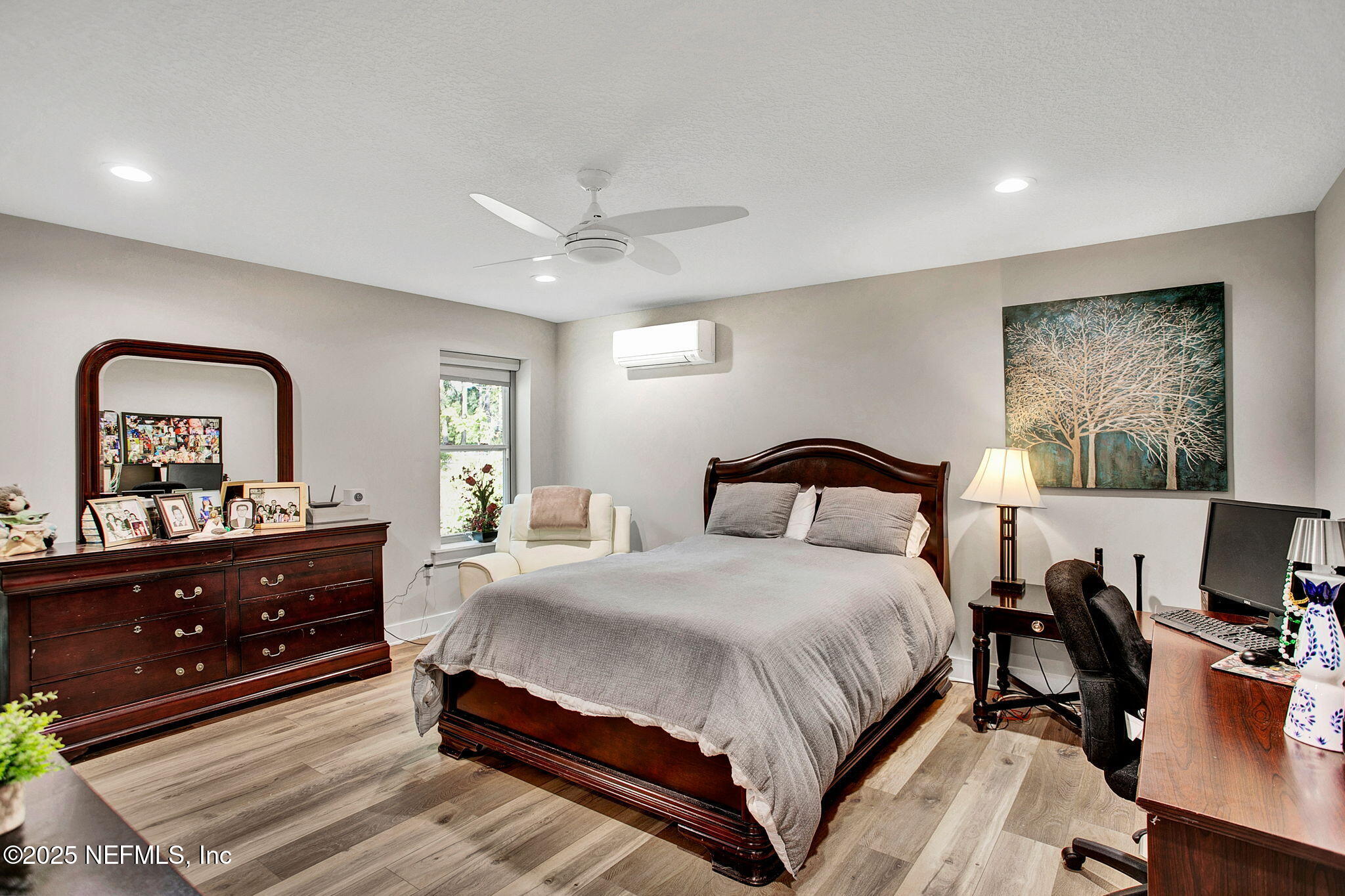 13224 Mandarin Road Jacksonville, FL 32223 - Photo 7 of 36 a bedroom with a bed and a flat screen tv