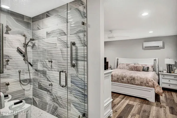 a bedroom with a bed and a shower