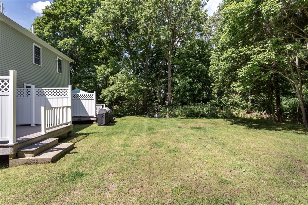 49 Beaver Street, Unit 49 Franklin, MA 02038 - Photo 30 of 46 a backyard of a house with yard and tree