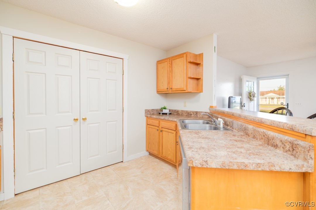 96 Horseshoe Road Jarratt, VA 23867 - Photo 12 of 36 Kitchen featuring sink, kitchen peninsula, and a t