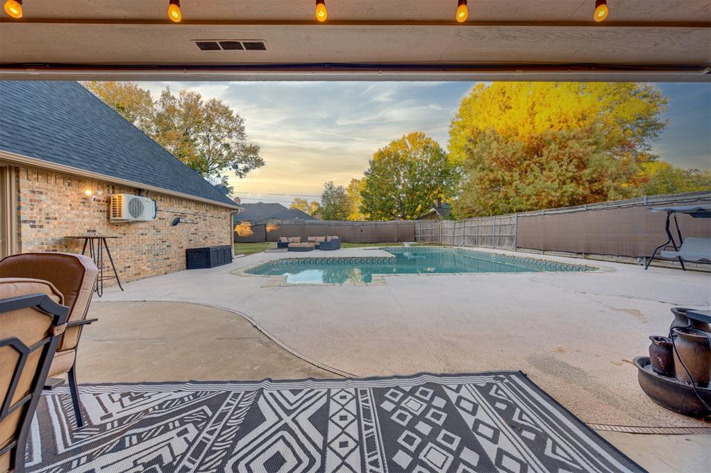 4115 Alpine Street Paris, TX 75462 - Photo 33 of 40 Pool at dusk featuring a fenced backyard and large patio