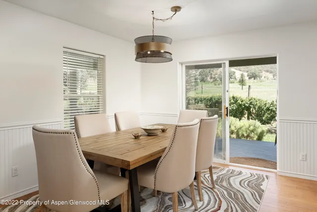 a view of a dining room with furniture window and wooden floor
