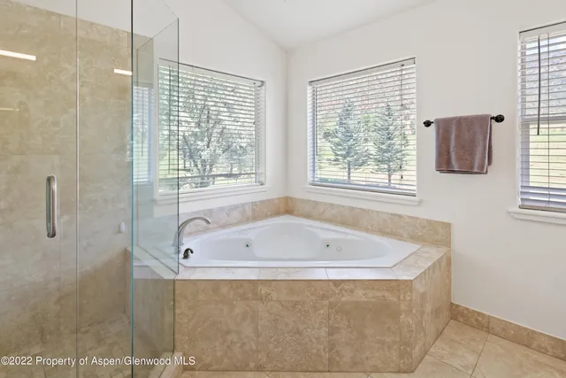 a bath tub sitting in a bathroom next to a window