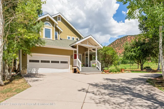 a view of a house with snow on the road