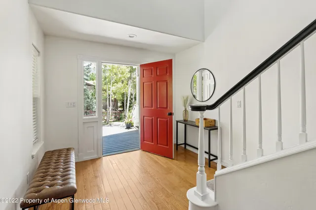 a view of an entryway with wooden floor and door