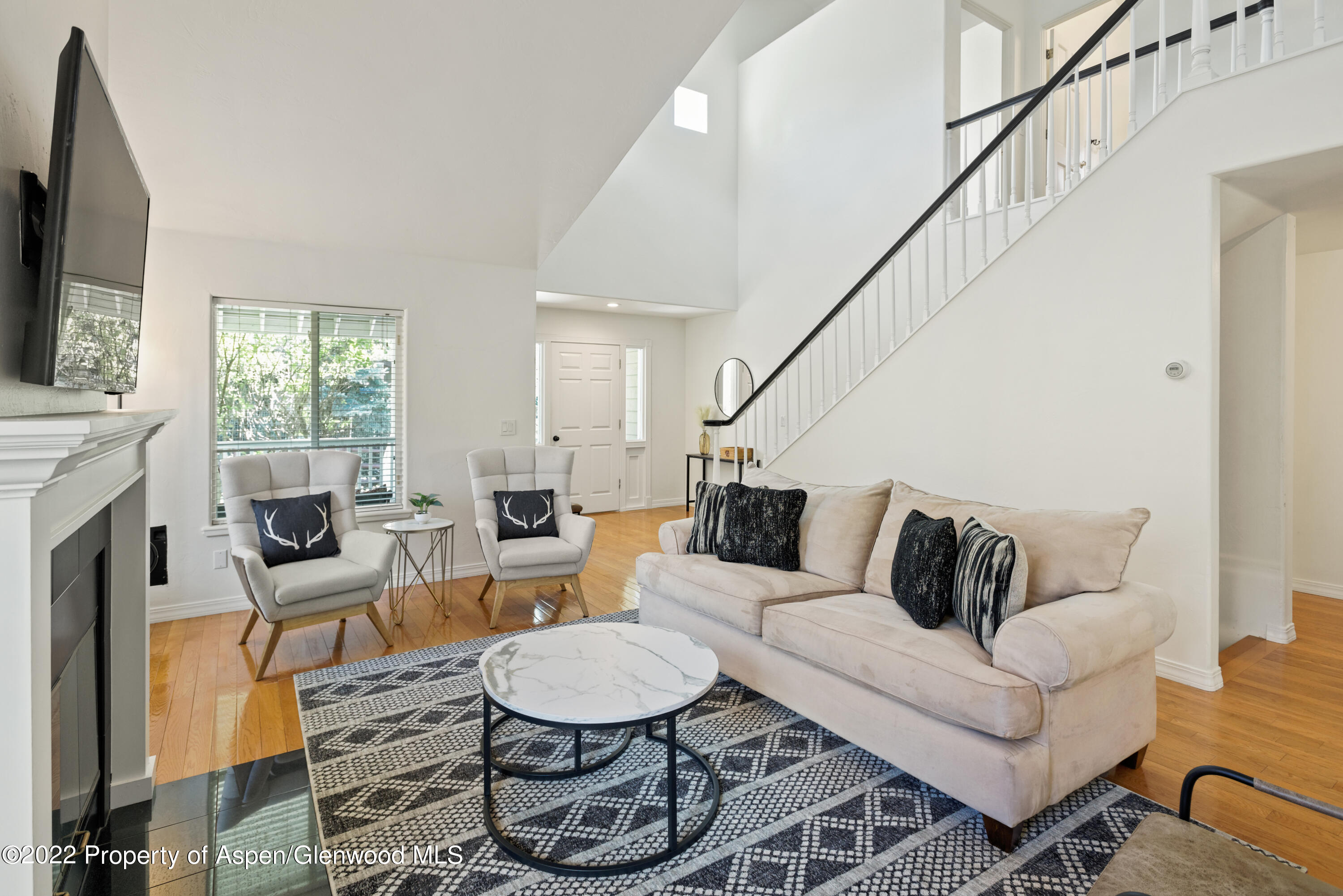 965 Lupine Circle Basalt, CO 81621 - Photo 4 of 31 a living room with furniture a fireplace and a flat screen tv